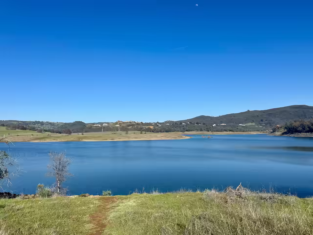 body of water on a sunny day with clear blue skies